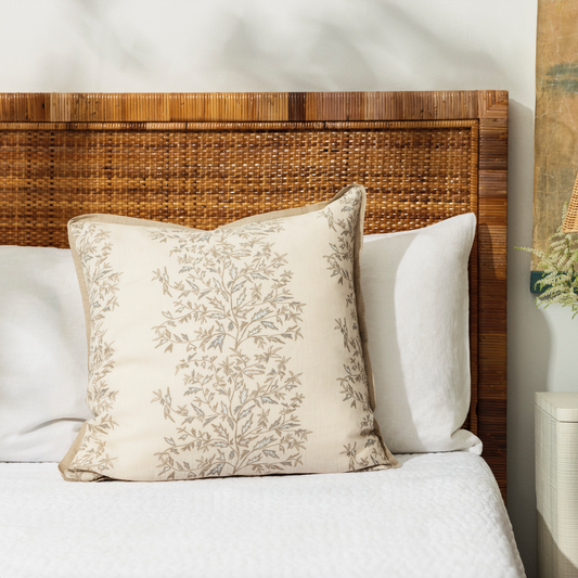 holly vine natural pillow set on a bed with white linen