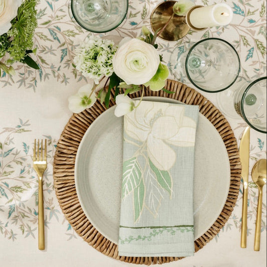 overhead shot of table with place setting and magnolia napkin