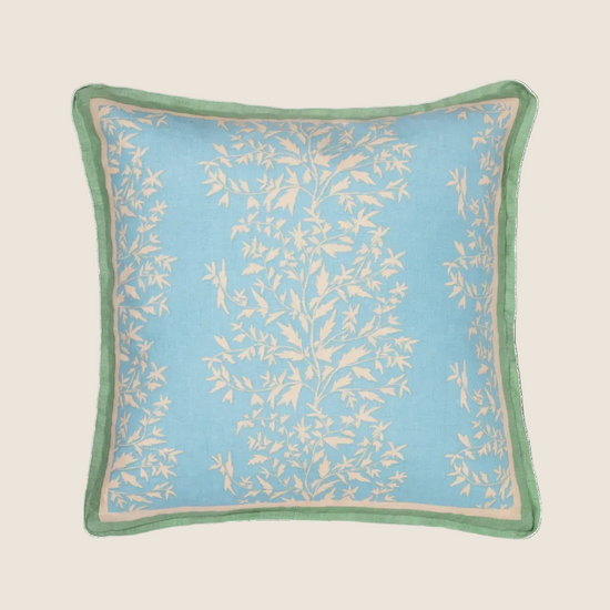 primrose azul pillow with contrasting green trim photographed against a white background