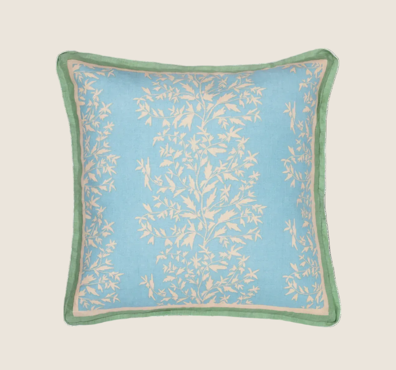 primrose azul pillow with contrasting green trim photographed against a white background