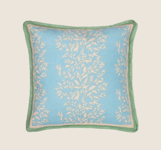 primrose azul pillow with contrasting green trim photographed against a white background