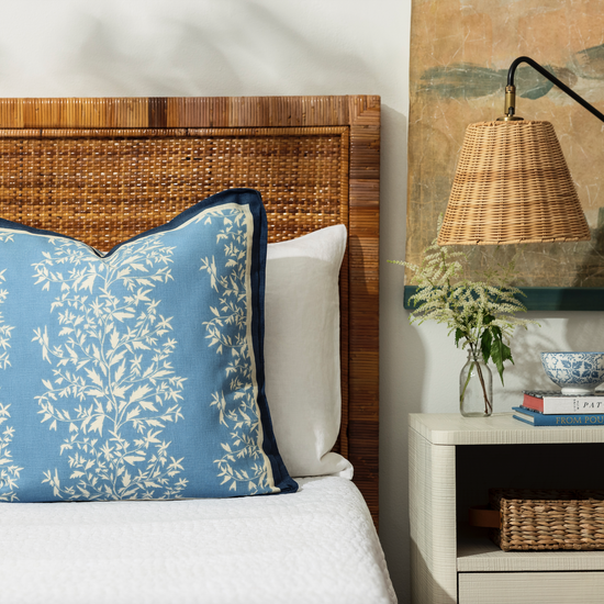 primrose lapis pillow with blue contrast trim styled on a bed with white bed linen