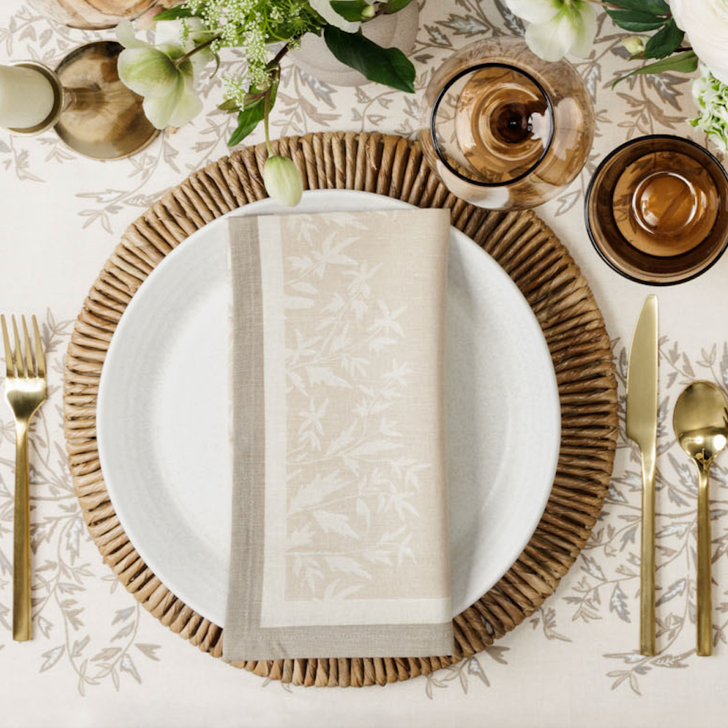 place setting on a white primrose tablecloth